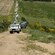 A caravan of Jeeps traveling through a rugged countryside